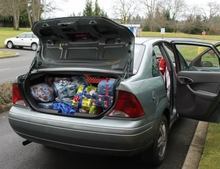 A silver car filled with Christmas presents