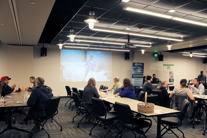 A group of people watching a presentation