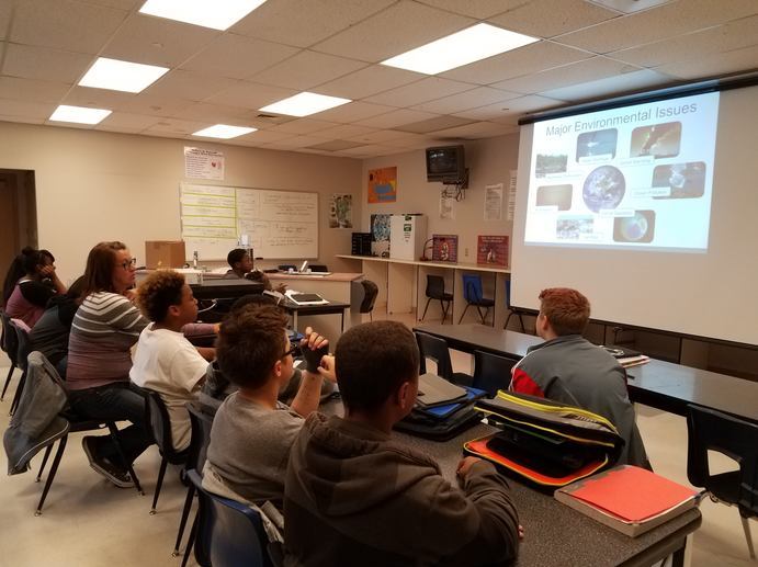 A group of people sitting in a classroom 