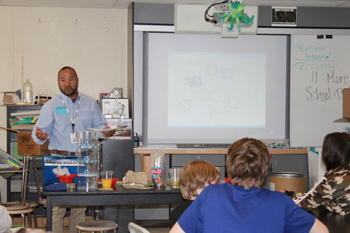 A teacher in front of a class of children